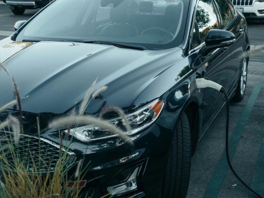 A black EV car charging at outdoor.