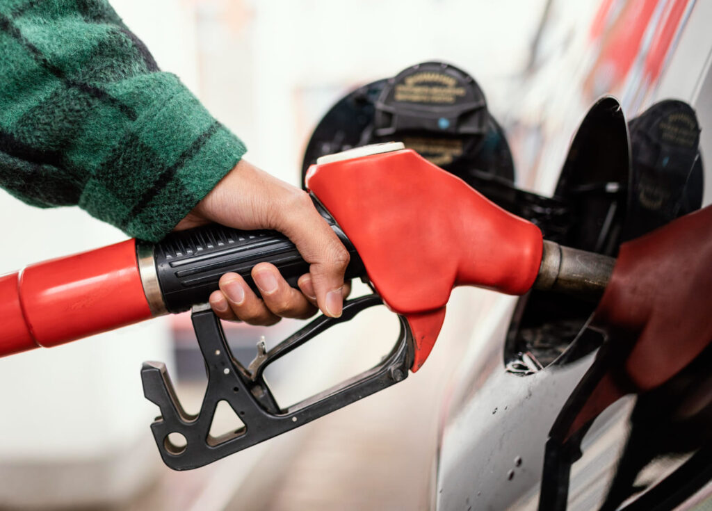 Filling petrol in a petrol station.