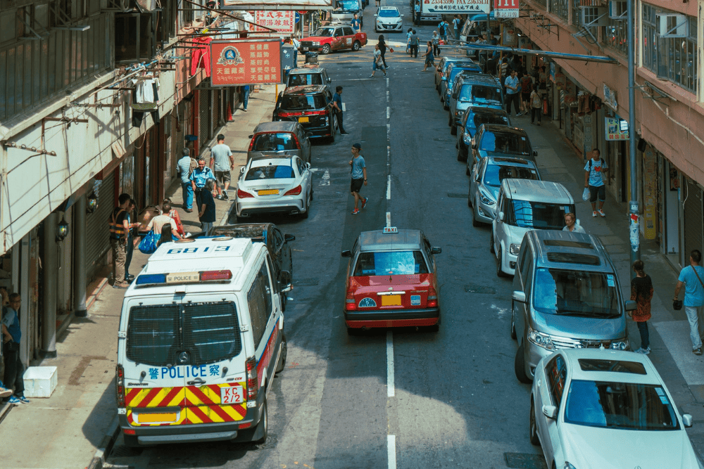 One of the Hong Kong streets with cars park on the roadside.