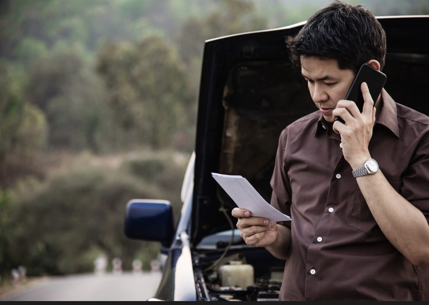A car driver calling towing service.